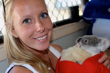 Cuddles with Greg, a baby koala in care with AACE.